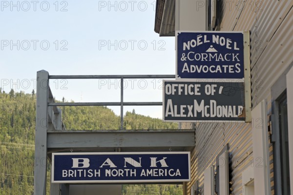 Historic signs advertising bank and lawyer, gold rush, gold mining town, Dawson City, Yukon