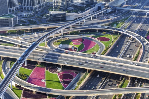 Intersection of Sheikh Zayed Road traffic on the road near the Burj Khalifa with Metro in Dubai,