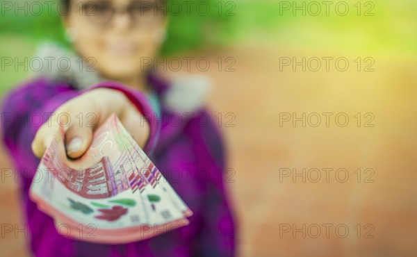 Young woman showing nicaraguan banknotes. Nicaraguan 500 cordobas banknotes