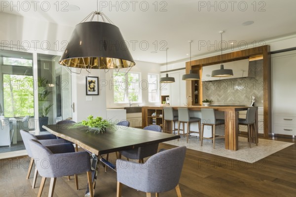 Chrome and walnut wood table with charcoal linen armchairs, large black and gold industrial style