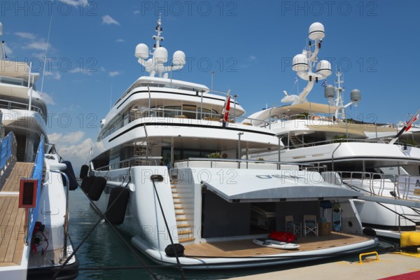White modern yacht in the harbour with a view of the blue sky, Mediterranean yacht show, harbour,