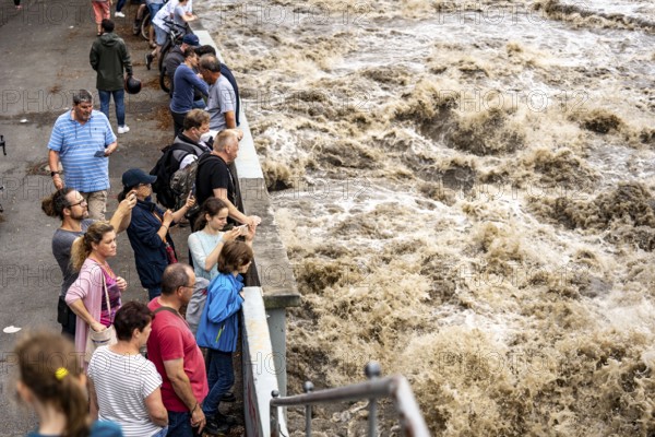 Weir of the Lake Baldeney in Essen, the masses of water roar through the open weirs, spectators,