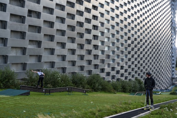 CopenHill, waste incineration plant and artificial ski slope, skiing with a view of the ski lift,