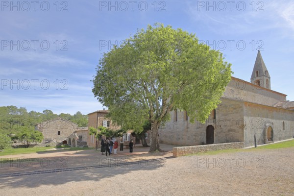 Romanesque abbey Le Thoronet and group of people, tourists, monastery complex, Cistercian abbey,