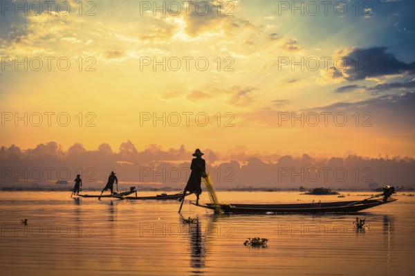 Myanmar travel attraction landmark, traditional Burmese fishermen sihouettes at Inle lake on