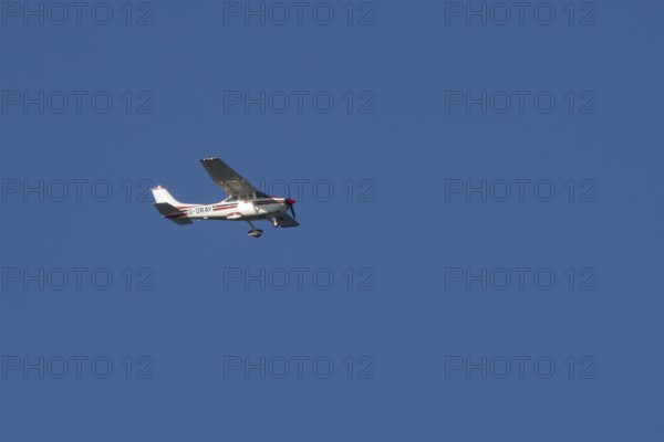 Cessna F182Q Skylane aircraft flying in a blue sky, England, United Kingdom, Europe