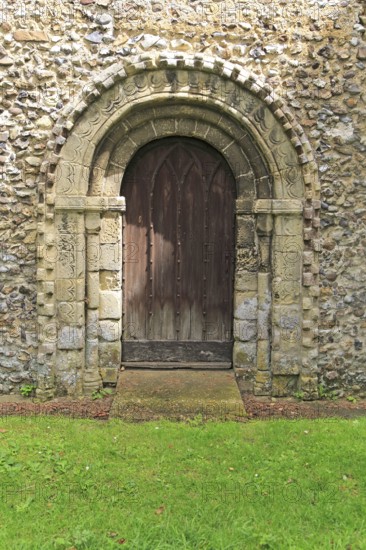 Norman style external doorway entrance, Saint Andrew church, Westhall, Suffolk, England, UK