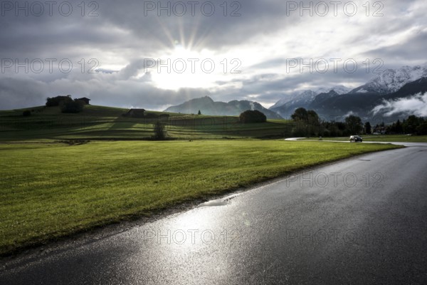 After a rain shower, the sun appears for a moment in the otherwise cloudy sky in front of the