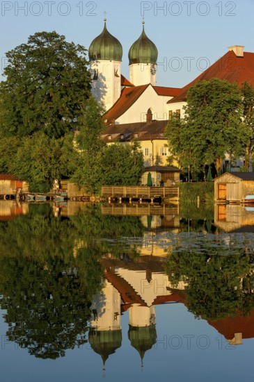 Romanesque Benedictine Abbey Seeon Monastery, monastery church St. Lambert with reflection in the
