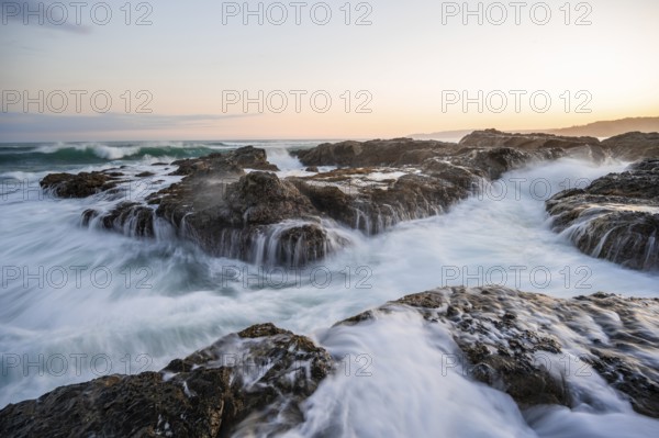 Waves washing over rocks by the sea, long exposure, coastal landscape at sunset, Playa Cocalito,
