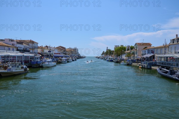 Coastal town with colourful houses, boats in the water, on a sunny day, summer, Le Grau-du-Roi,