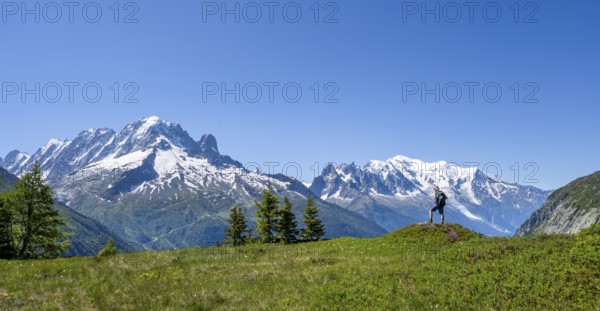 Mountaineer in front of a mountain panorama with glaciated mountain peaks, Aiguille Verte with