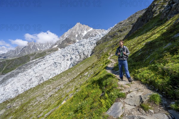 Mountaineer on the hiking trail La Jonction, mountain landscape with glacier Glacier des Bossons
