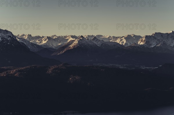 Trail running in autumn on the Jochberg on Lake Walchensee against the wonderful backdrop of the