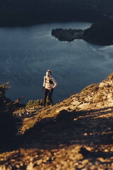 Trail running in autumn on the Jochberg on Lake Walchensee against the wonderful backdrop of the