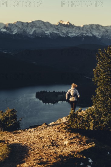 Trail running in autumn on the Jochberg on Lake Walchensee against the wonderful backdrop of the