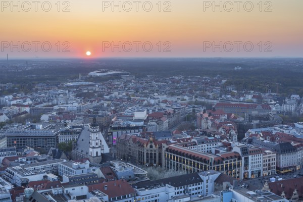 View of the city from the City Tower at sunset, St Thomas' Church, Red Bull Arena and Auwald