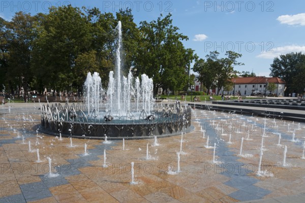 Large fountain with bubbling water in the centre of a park, Litewski Square, Lithuanian Square,