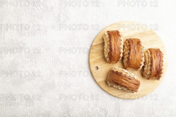 Traditional armenian dessert gata on a gray concrete background and wooden board. top view, flat