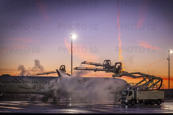 Frost at the airport, a Turkish Airlines aircraft is de-iced in front of sunrise. Airbus A321-231,