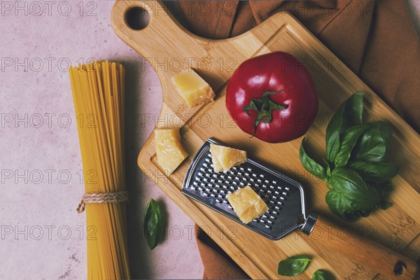 Raw pasta with ingredients on a beige background, top view, rustic style, selective focus, no