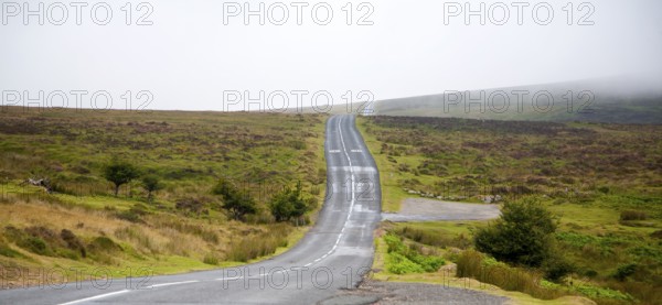 Empty road crossing moorland near Postbridge, Dartmoor national park, Devon, England, UK