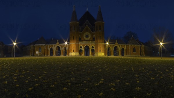 Main entrance of the cemetery in Hanover Stöcken with a lawn with crocuses in the foreground, dutch
