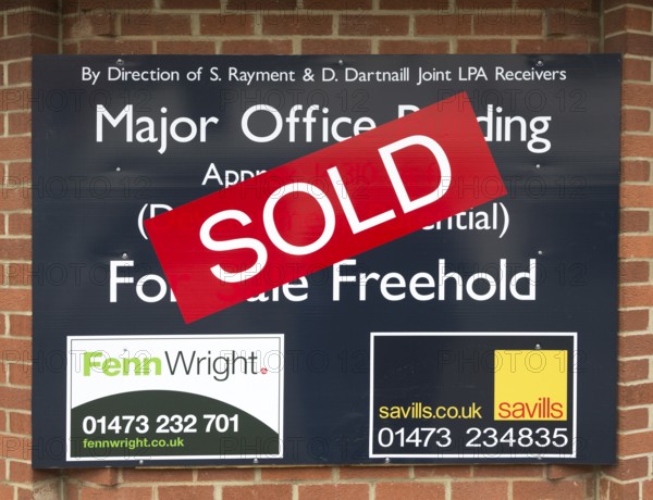 Close up of Sold estate agent sign for major office building commercial property, Ipswich, Suffolk,