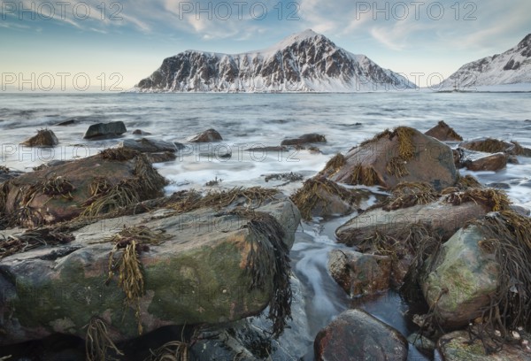 Long exposure, winter evening mood at Skagsanden, stones on the beach at Flakstad, Flakstadøy,