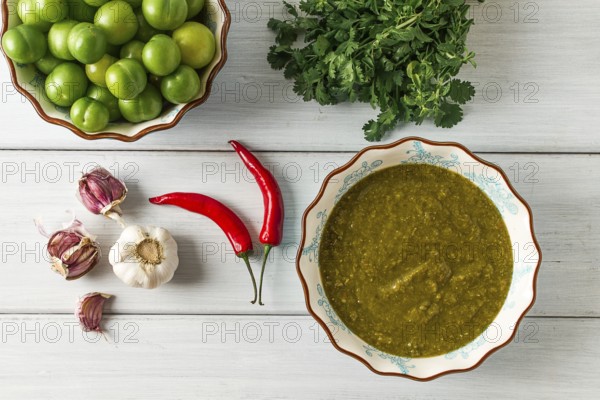 Tkemali sauce, traditional Georgian cuisine, green cherry plum, with ingredients for sauce,