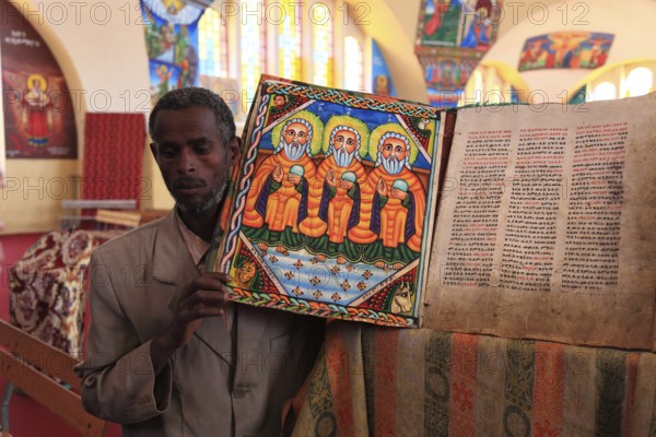 Tigray region, Axum, Aksum, St Mary's Cathedral, Maryam Tsion, inside, church servant shows old