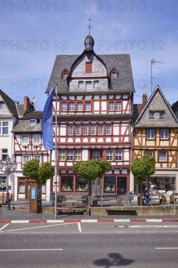 Multi-storey half-timbered house and European flag on the main street in Adenau, Eifel, Ahrweiler