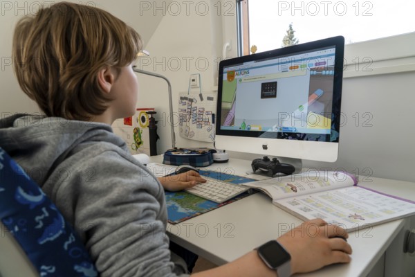 Young, primary school pupils, home learning, doing schoolwork, distance learning, virtual
