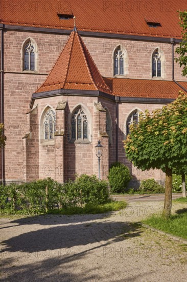 Church of St. Nicholas, façade, windows, roofs of red plain tiles, trees, greenery, sunlight,