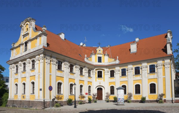 Historic baroque building with yellow façade and red tiled roof, Poznan Sródka, Former Philippine