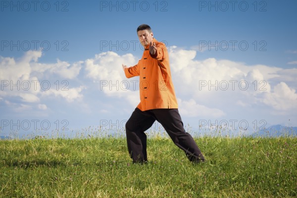 A man doing Qi-Gong in the green nature