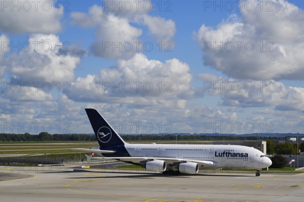 Lufthansa Airbus A380-800 taxiing under blue sky from Runway North on Apron 2 East to Terminal 2,