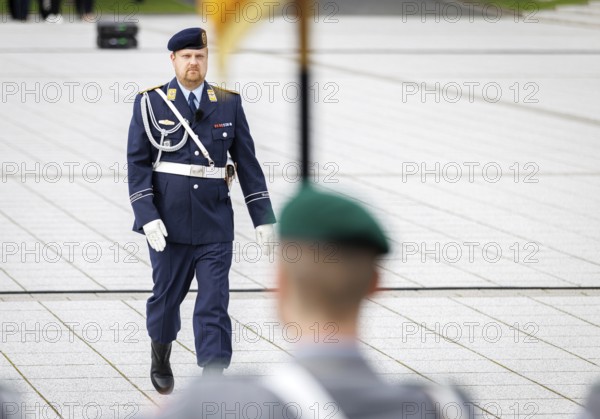 An air force soldier of the guard battalion gives commands to army soldiers of an honour formation