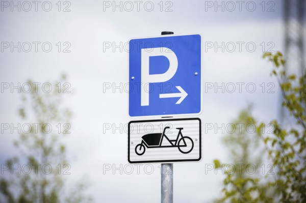 Symbolic photo. A sign for reserved parking spaces for cargo bikes on a newly built car park.