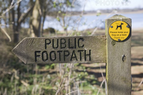 Arrow direction pointer on wooden public footpath sign, Sutton, Suffolk, England, United Kingdom,
