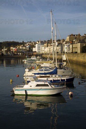 Boats in the harbour and the town of St Peter Port, Guernsey, Channel Islands, UK, Europe