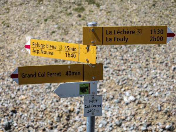 Hiking path, pass petit col Ferret, border Switzerland-Italy, signposts, view towards Val de