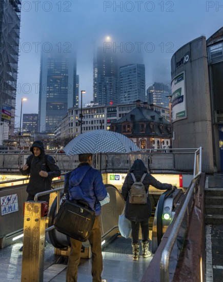 Rainy weather, freezing rain, entrance to Hauptwache underground station, high-rise skyline in