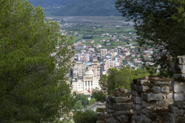 Raised view through trees over city of Berat, Albania, Europe