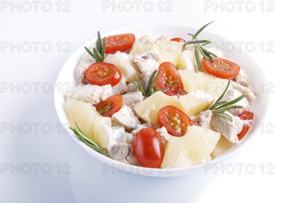 Chicken fillet salad with rosemary, pineapple and cherry tomatoes isolated on white background.