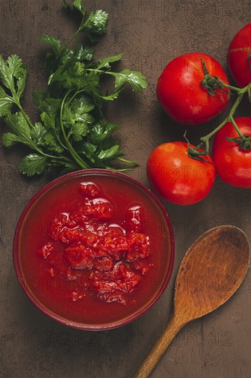Tomatoes in their own juice, sliced, tomato sauce, tomatoes, in a cup, top view, close-up, no