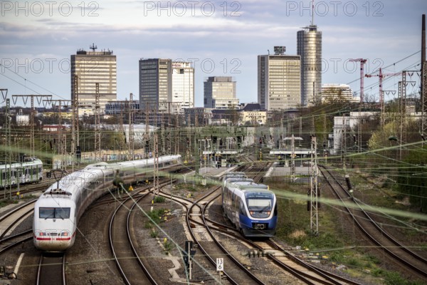 Train on the tracks west of Essen central station, skyline of the city centre, ICE train, North