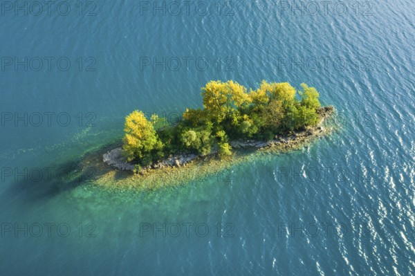 Bird's eye view of the chive island in the turquoise waters of Lake Walen in the canton of St.