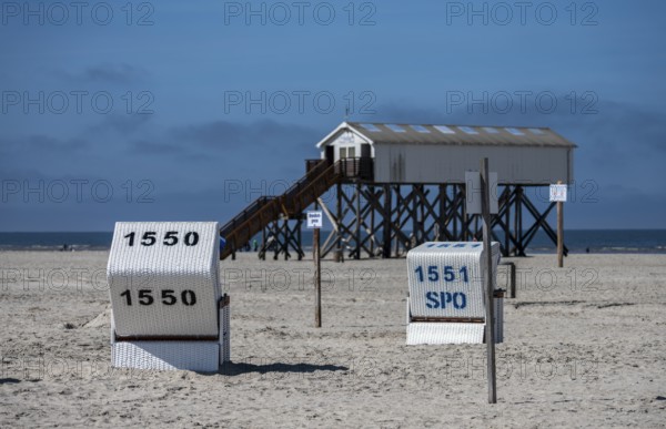 Beach chairs and signs on the sandy beach of the North Sea, Sankt Peter-Ording, Schleswig-Holstein,