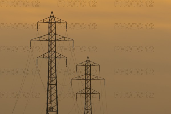 Electricity pylons silhouette at sunset, Kent, England, United Kingdom, Europe